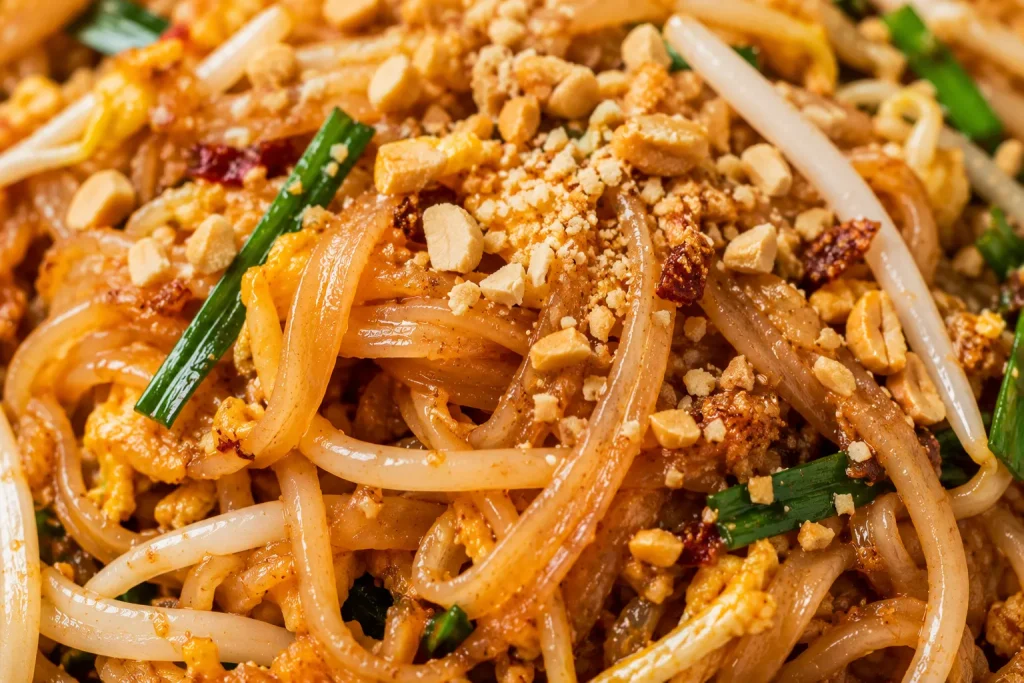 Close-up of glossy pad Thai noodles with peanuts