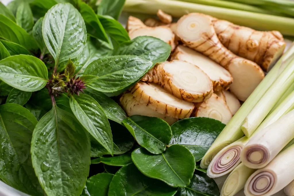 Fresh Thai herbs used to create aromatic flavor layers